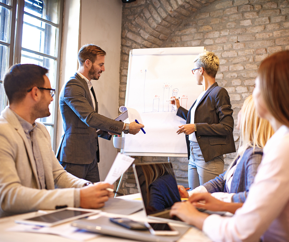 Team watching employee training video during onboarding session in modern office setting