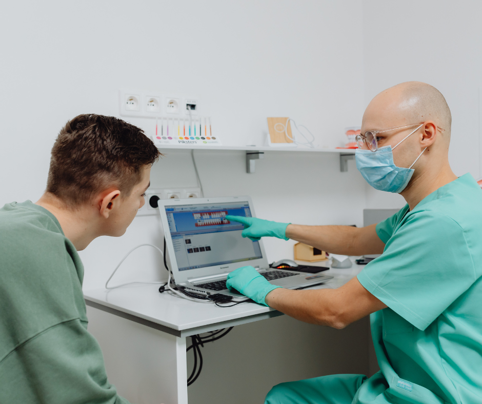Doctor explaining a medical procedure to a patient using visuals in a clinic setting.